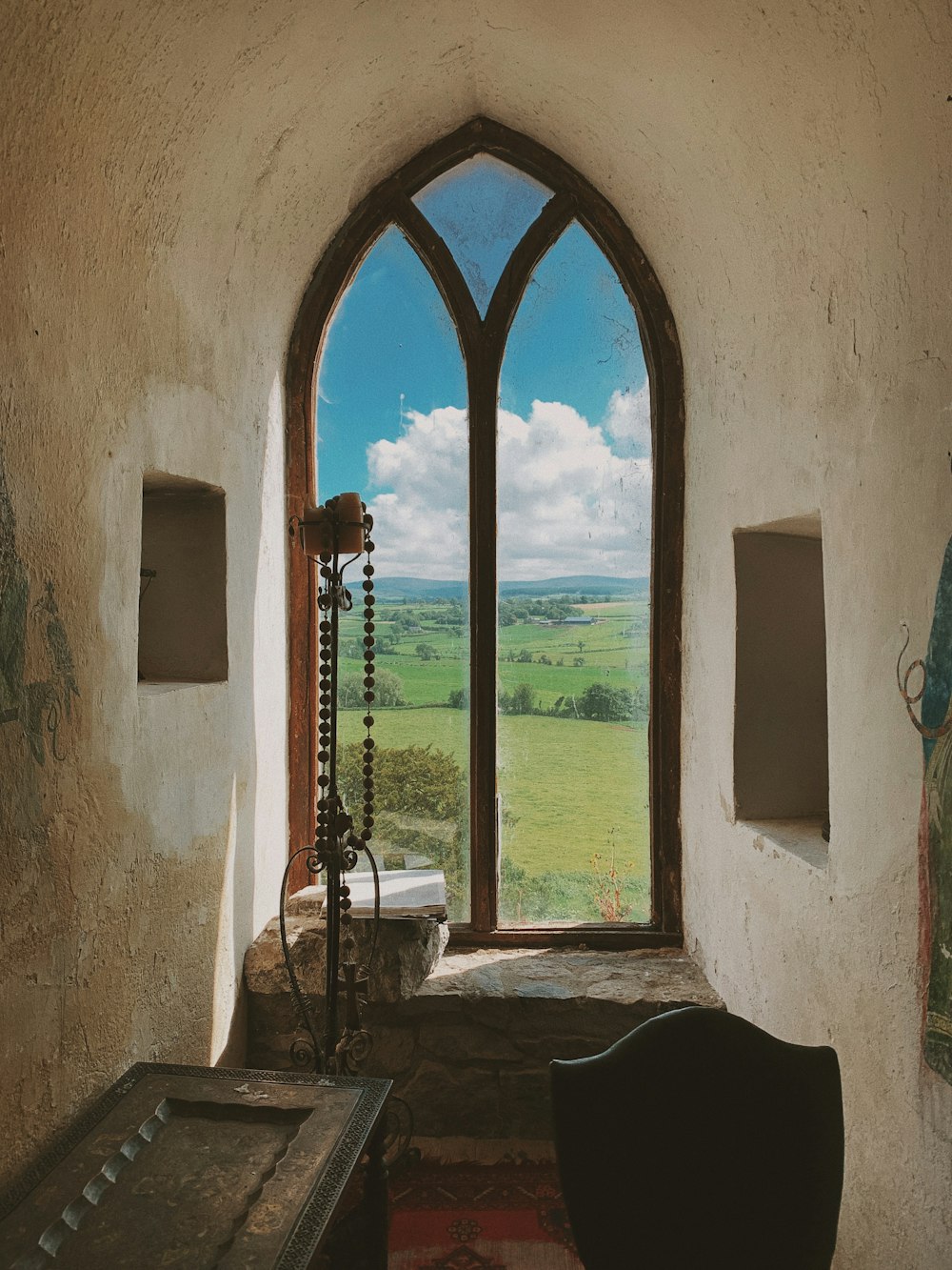 a doorway with a view of a field and a field