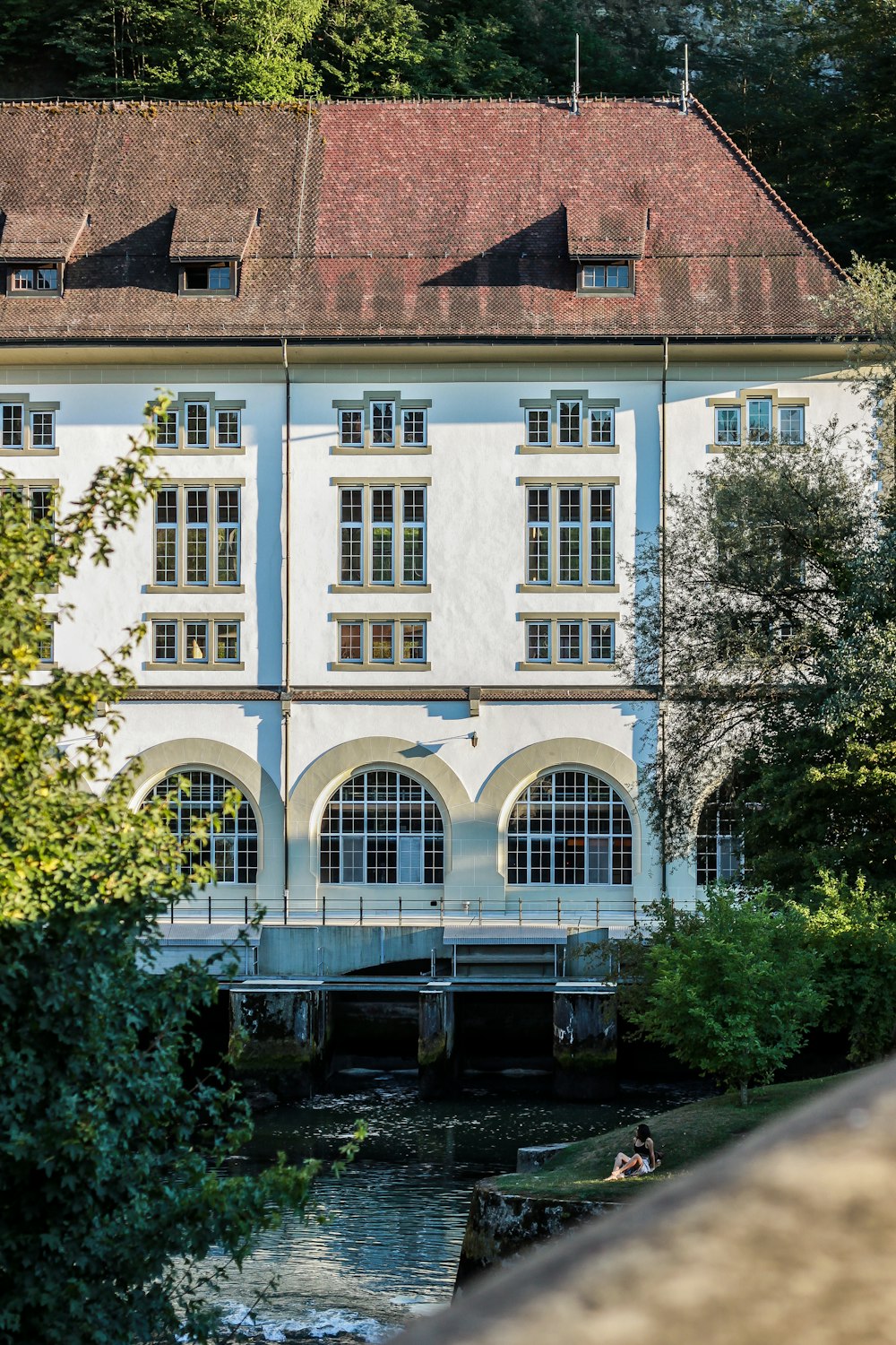 a building with a bridge and trees