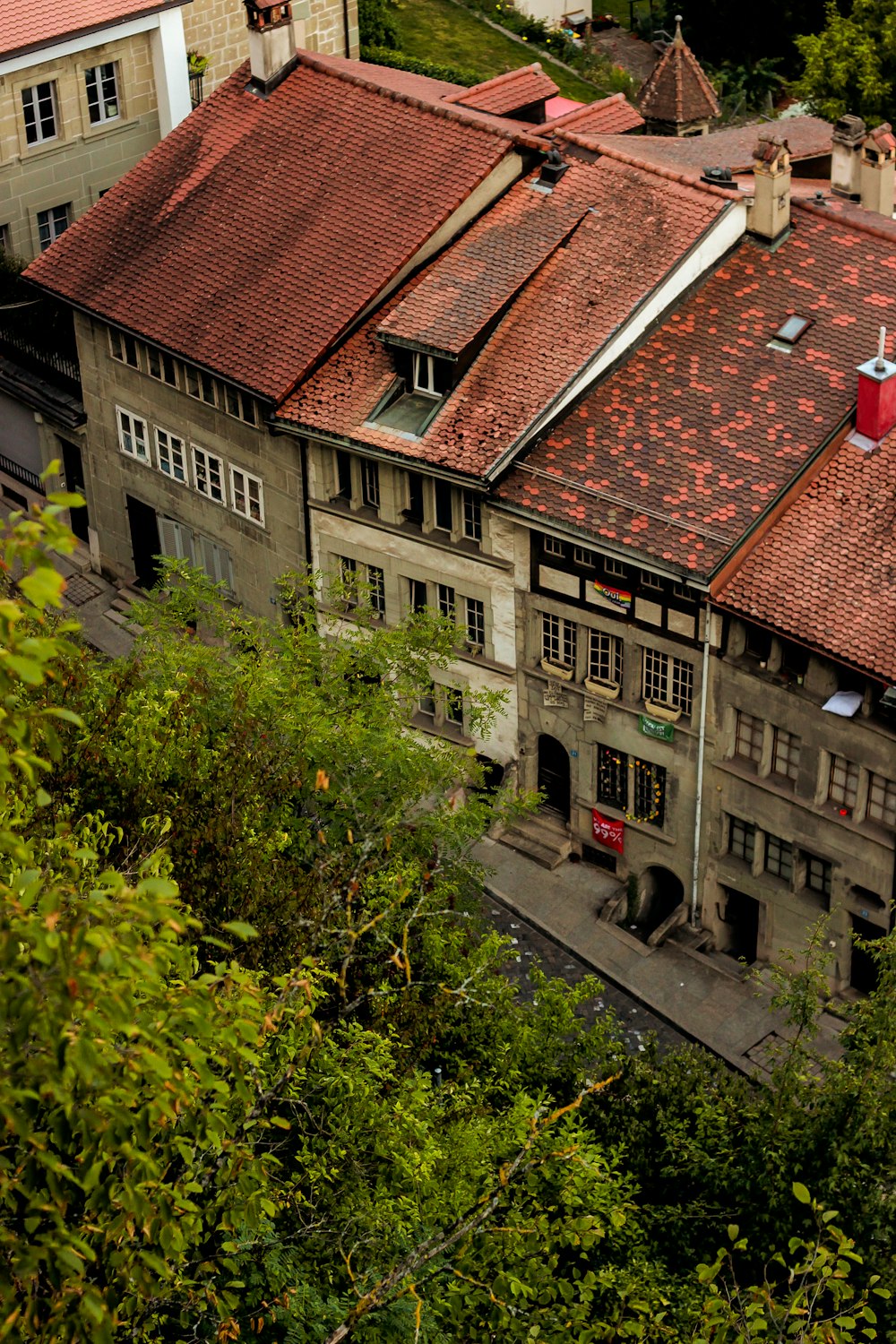 a group of buildings with trees in front of them