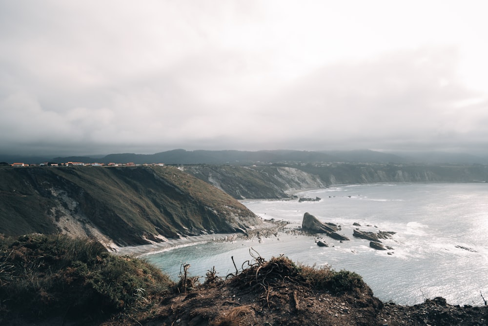 a rocky beach next to a body of water