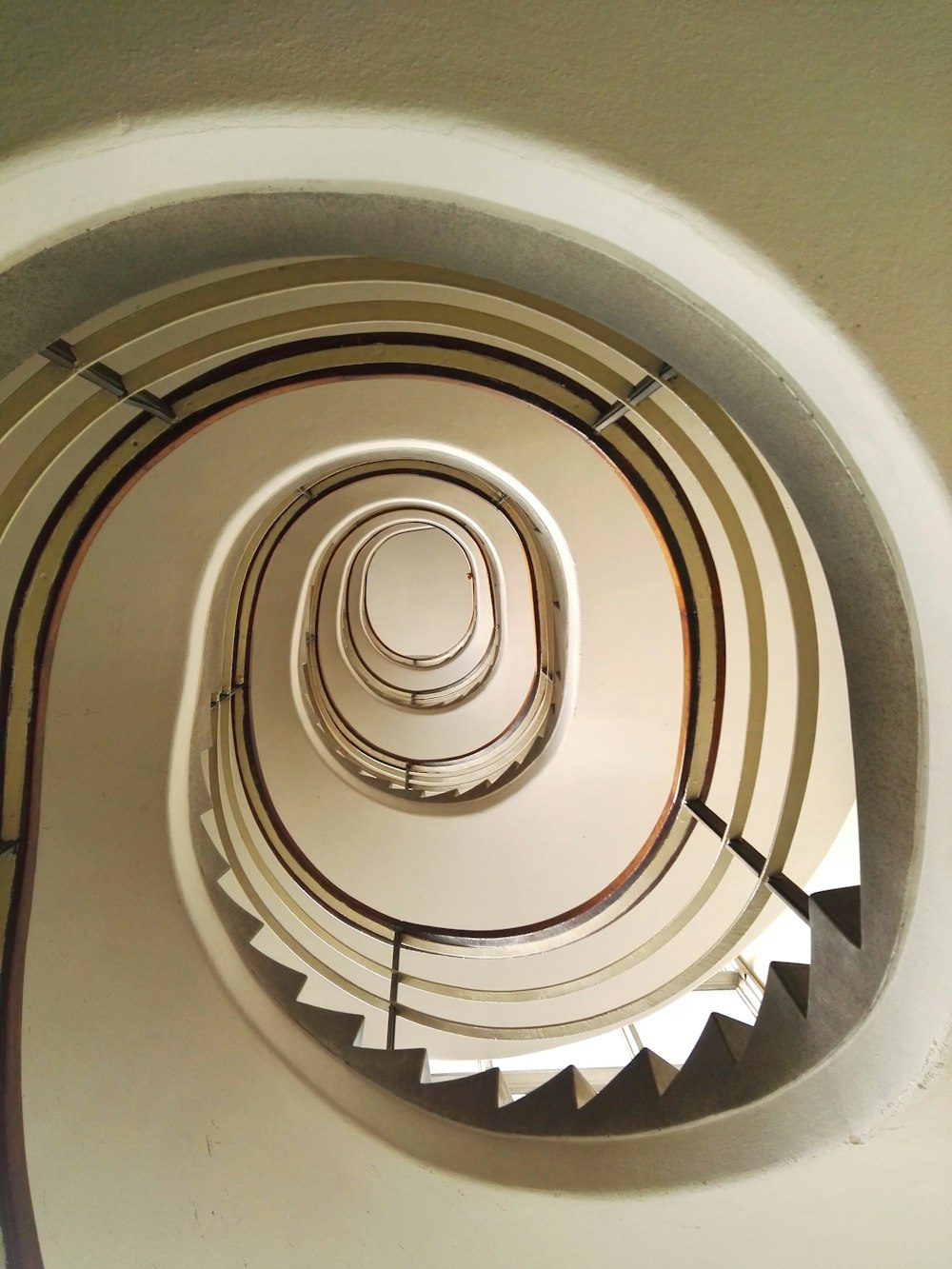 a spiral staircase with a light at the top