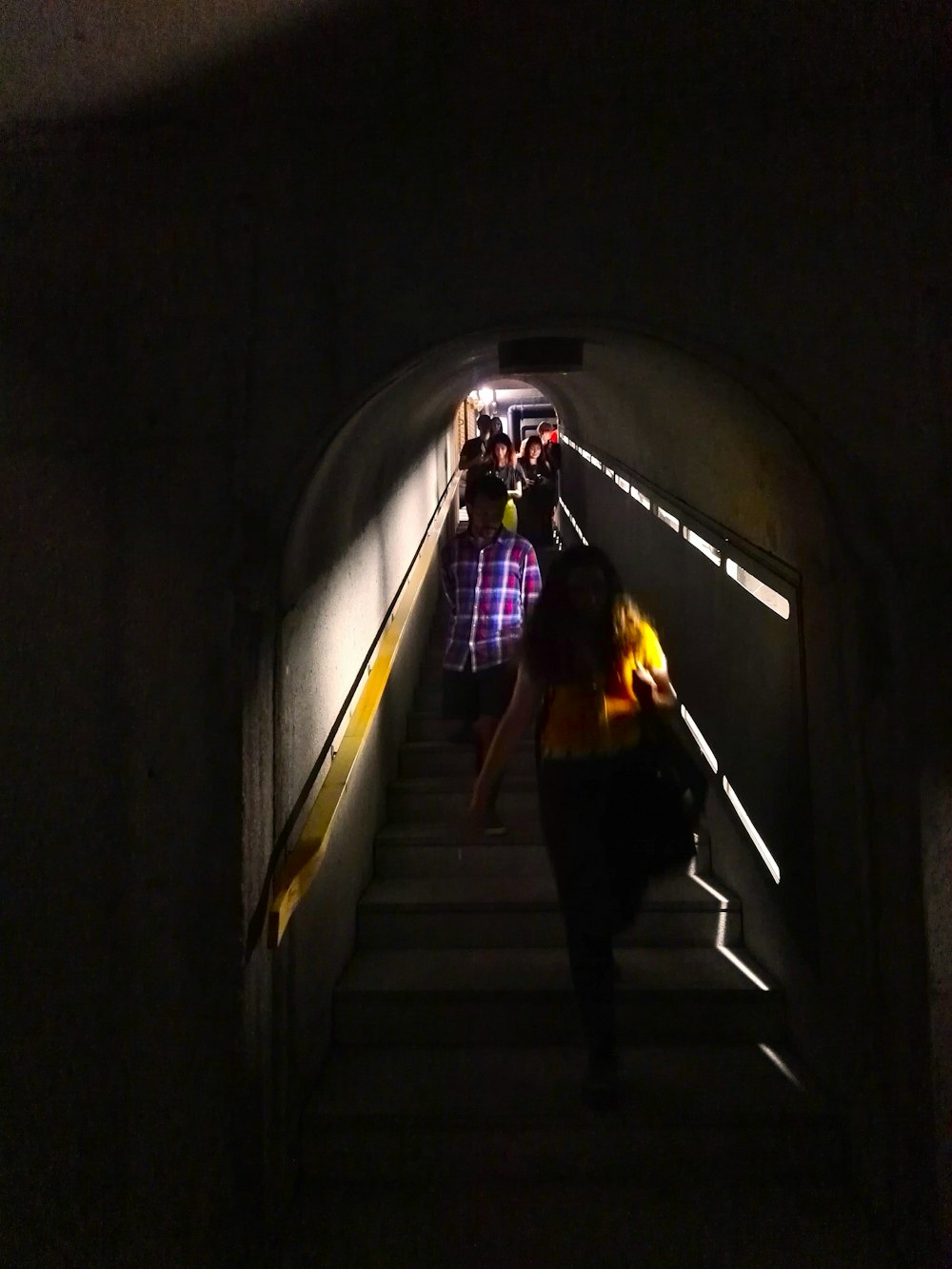 a couple of people taking pictures of a tunnel