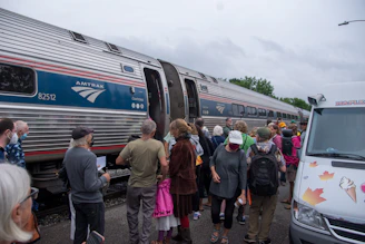 A friendly customer service representative wearing a headset ready to assist with Amtrak AutoTrain bookings.