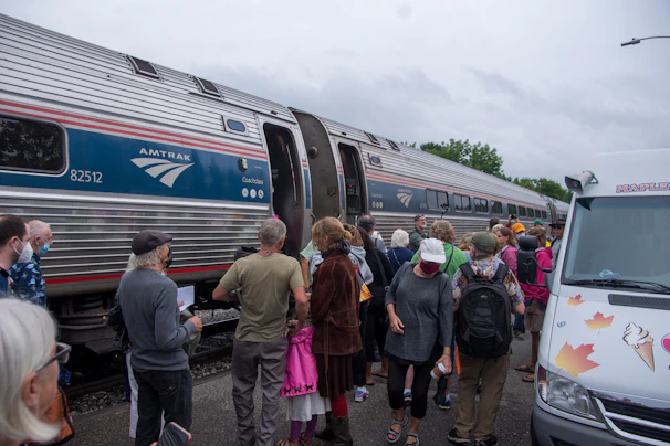 Passengers boarding the Auto Train with their cars, smiling and ready for the trip ahead.
