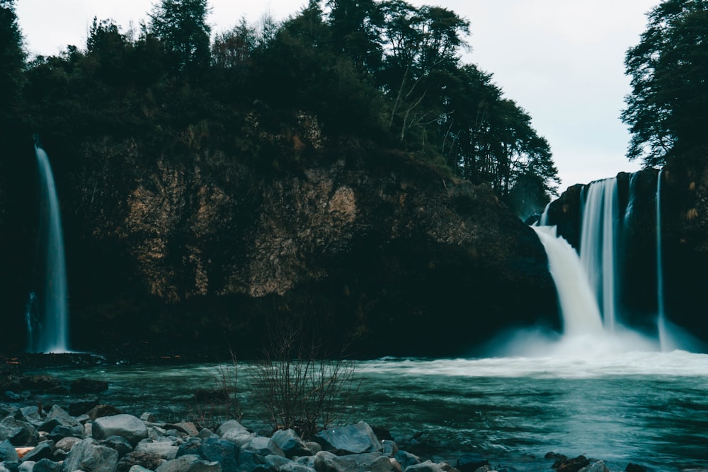 a waterfall with trees around it