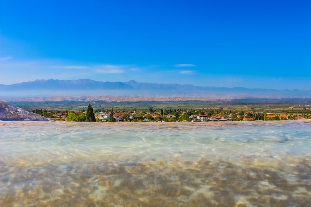 a body of water with a town in the distance