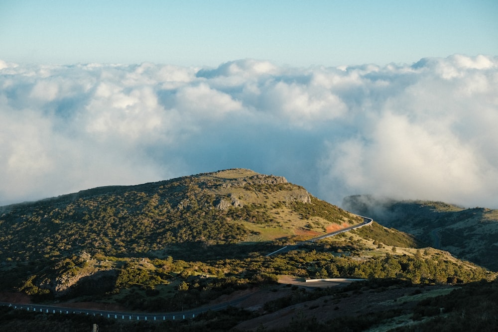 a mountain with clouds above it