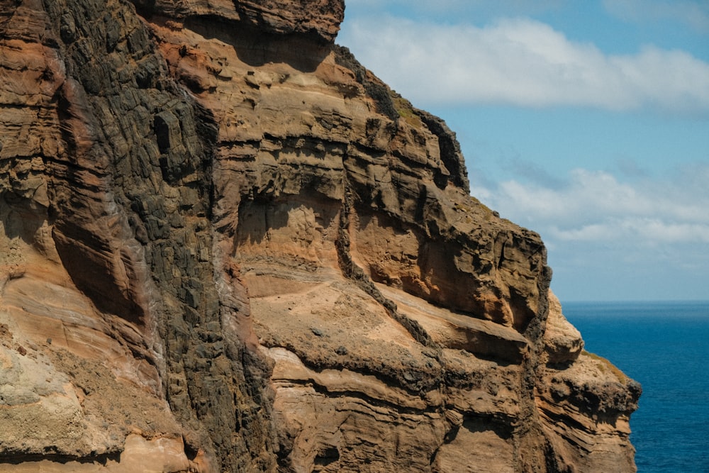 a cliff with a body of water below