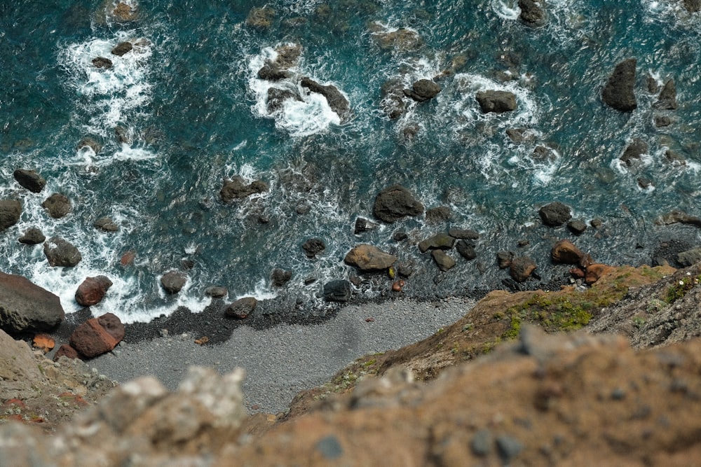 a rocky beach with a stream of water