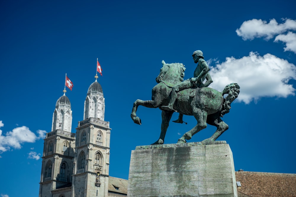 a statue of a person riding a horse in front of a building