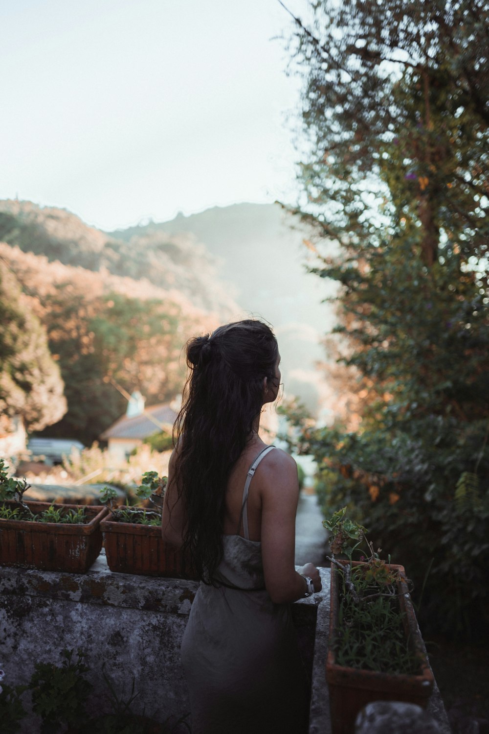 a woman standing on a balcony overlooking a valley