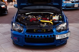 a blue car with a spoiler