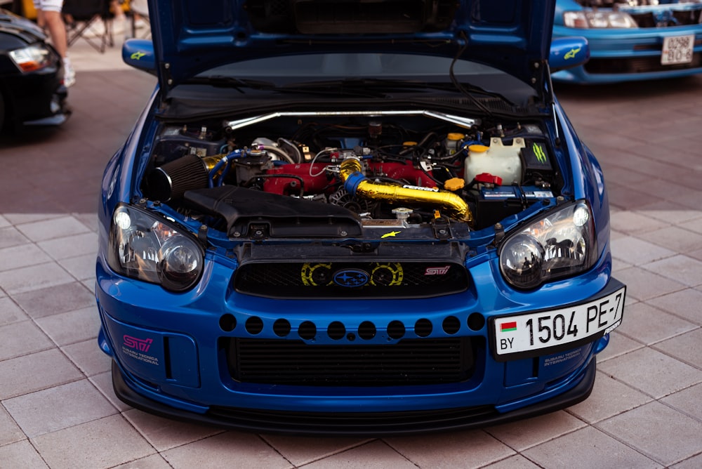 a blue car with a spoiler