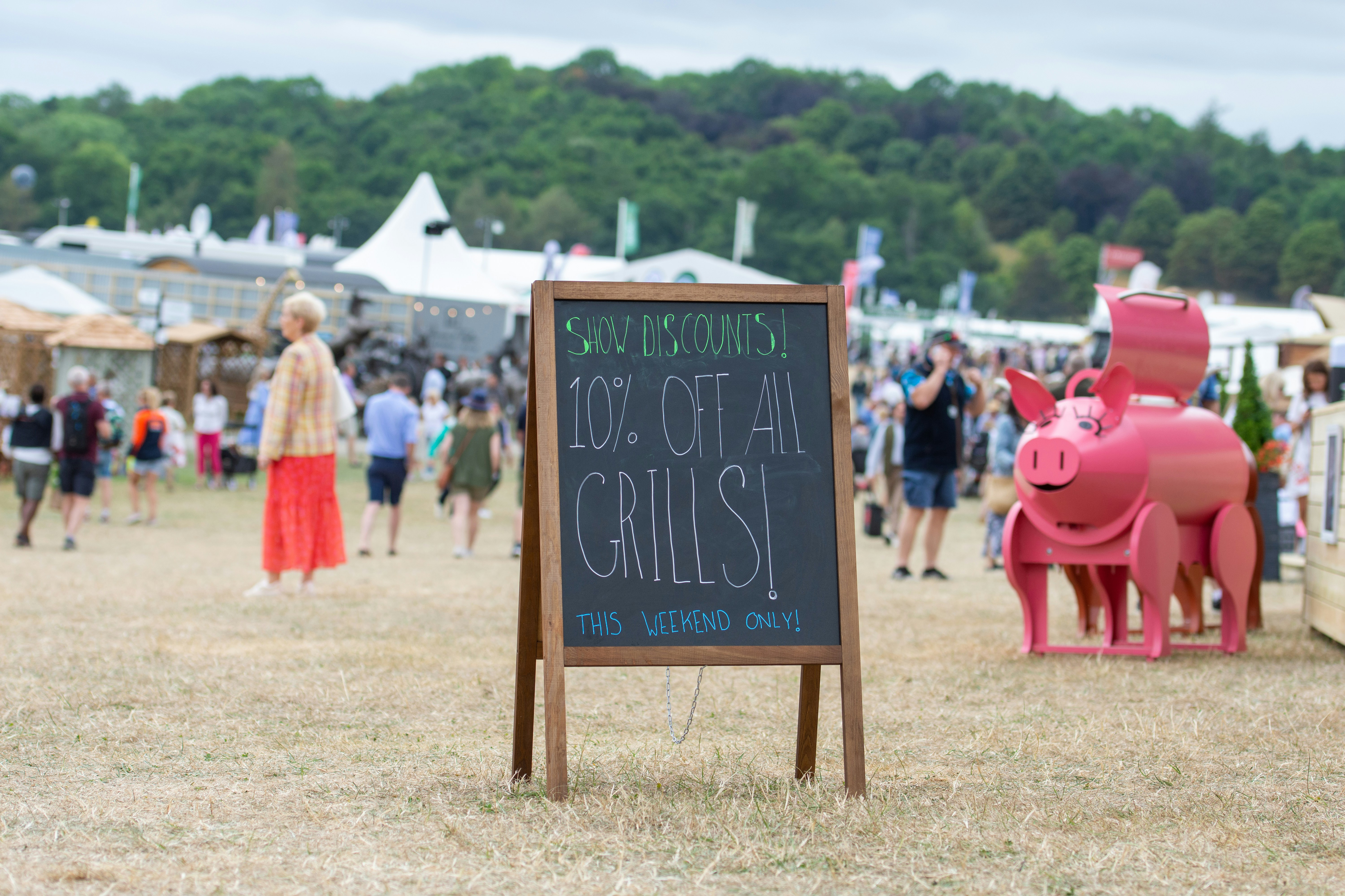 a sign with a person in a garment next to a sign