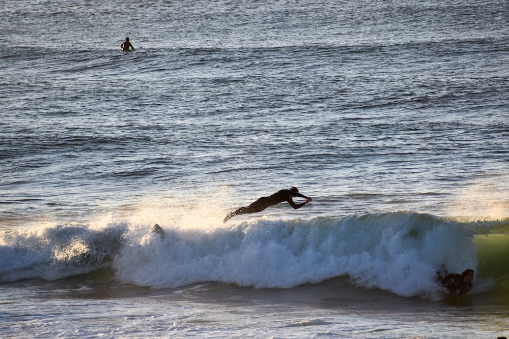 a group of surfers are riding a wave
