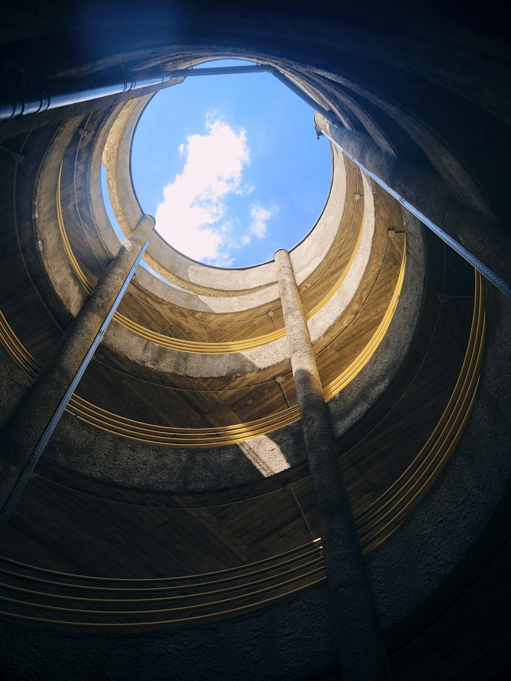 a spiral staircase with a blue sky