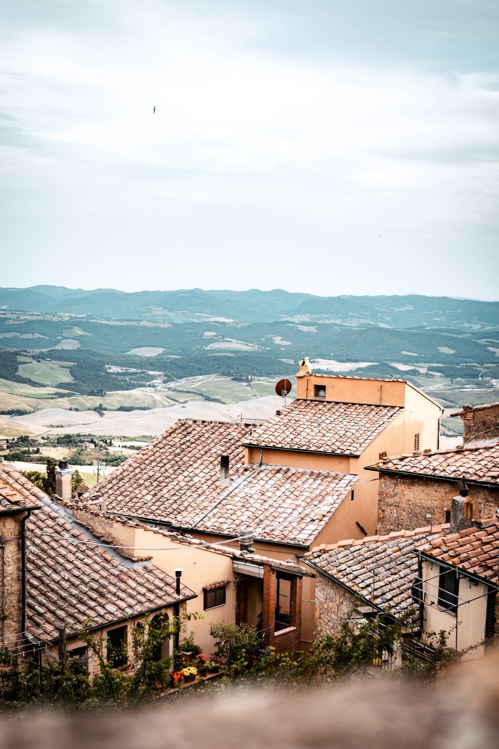 a group of rooftops with a valley in the background