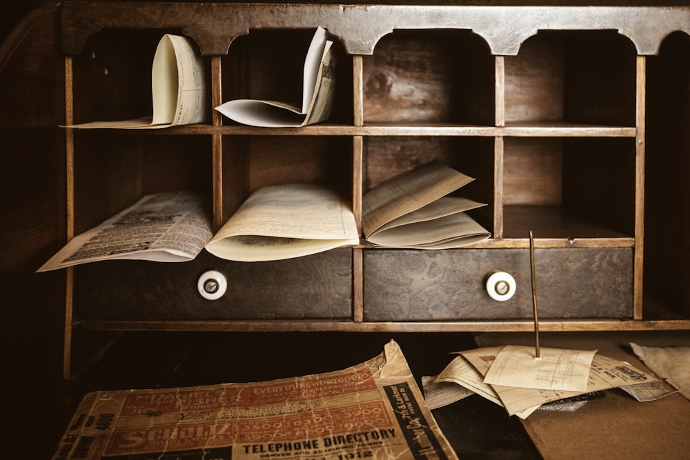 a shelf with books and papers on it