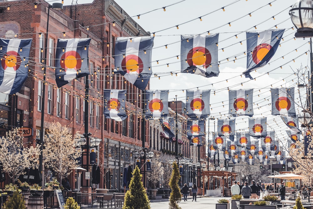 a group of people walking on a street with christmas decorations