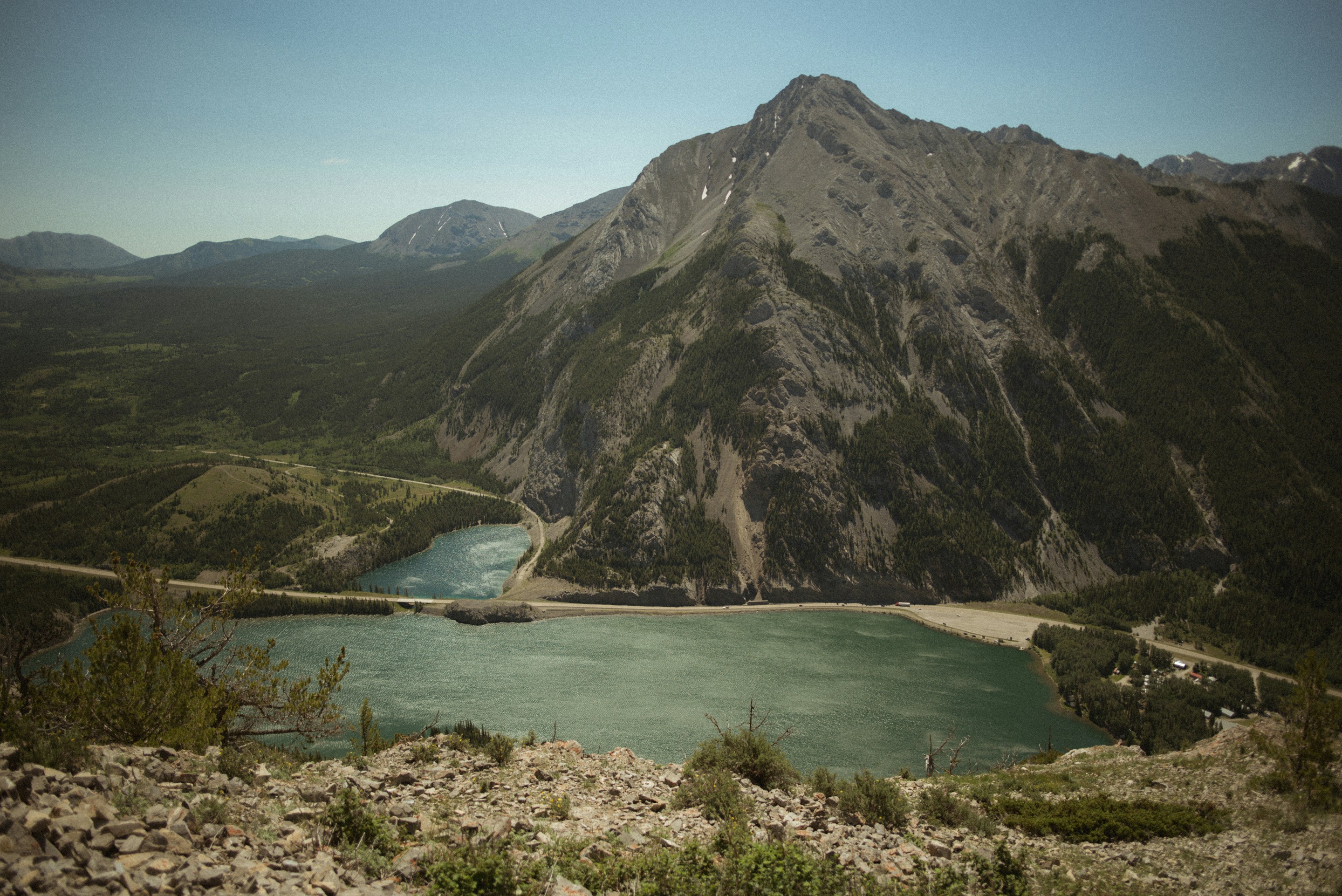 a body of water with mountains in the background