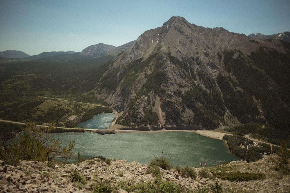 a body of water with mountains in the background