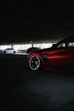 a red sports car parked in a parking lot