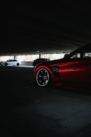 a red sports car parked in a parking lot