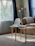 Cozy living room corner featuring a faux leather accent chair beside a round coffee table.