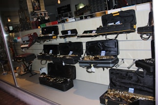 A cozy music shop corner with various percussion and wind instruments displayed.