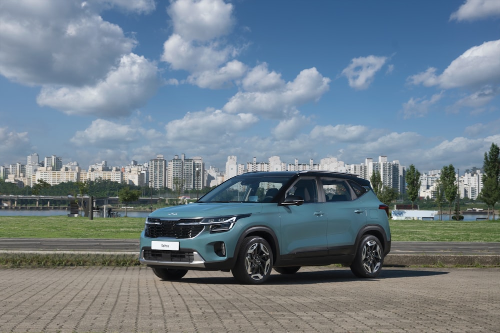 a car parked on a road with a city in the background