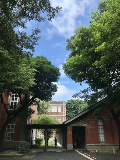 A serene view of the pesantren's green courtyard with students walking between buildings.