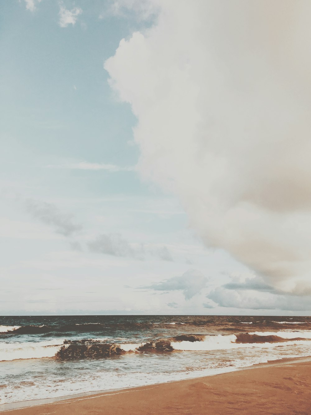 a beach with rocks and water