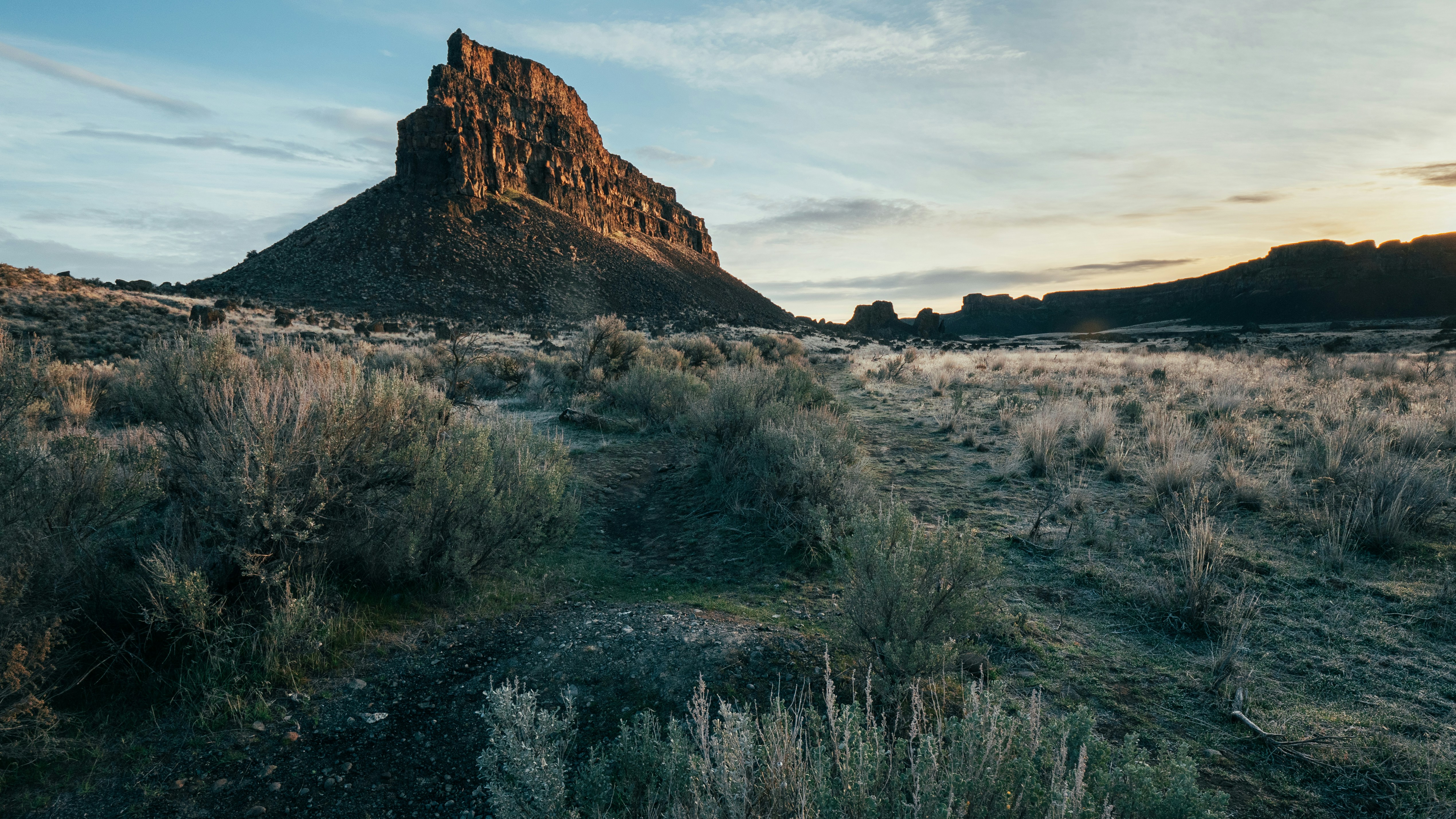 a rocky mountain with a valley below