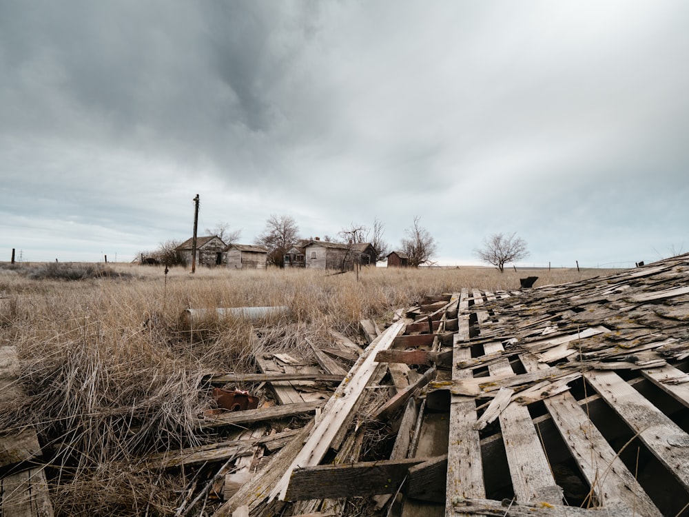 a field with a fence and a house in the distance