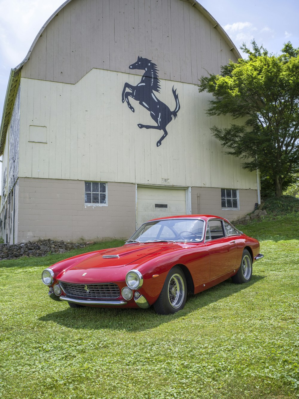 a red car parked in front of a white building