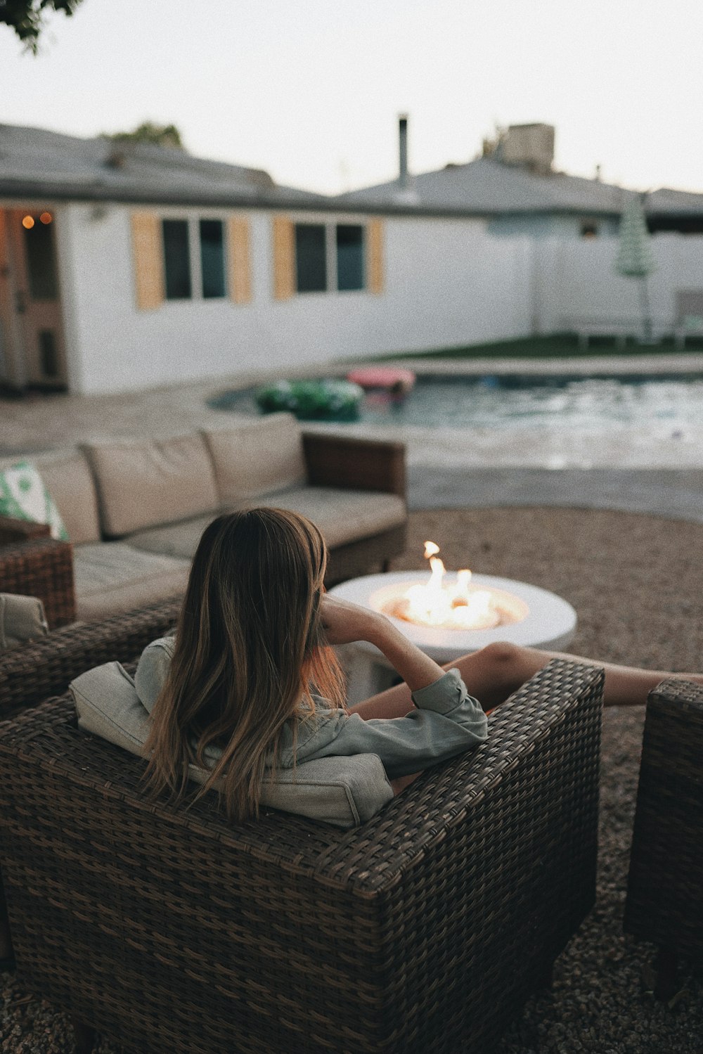 a person sitting on a bench with a fire in the hand