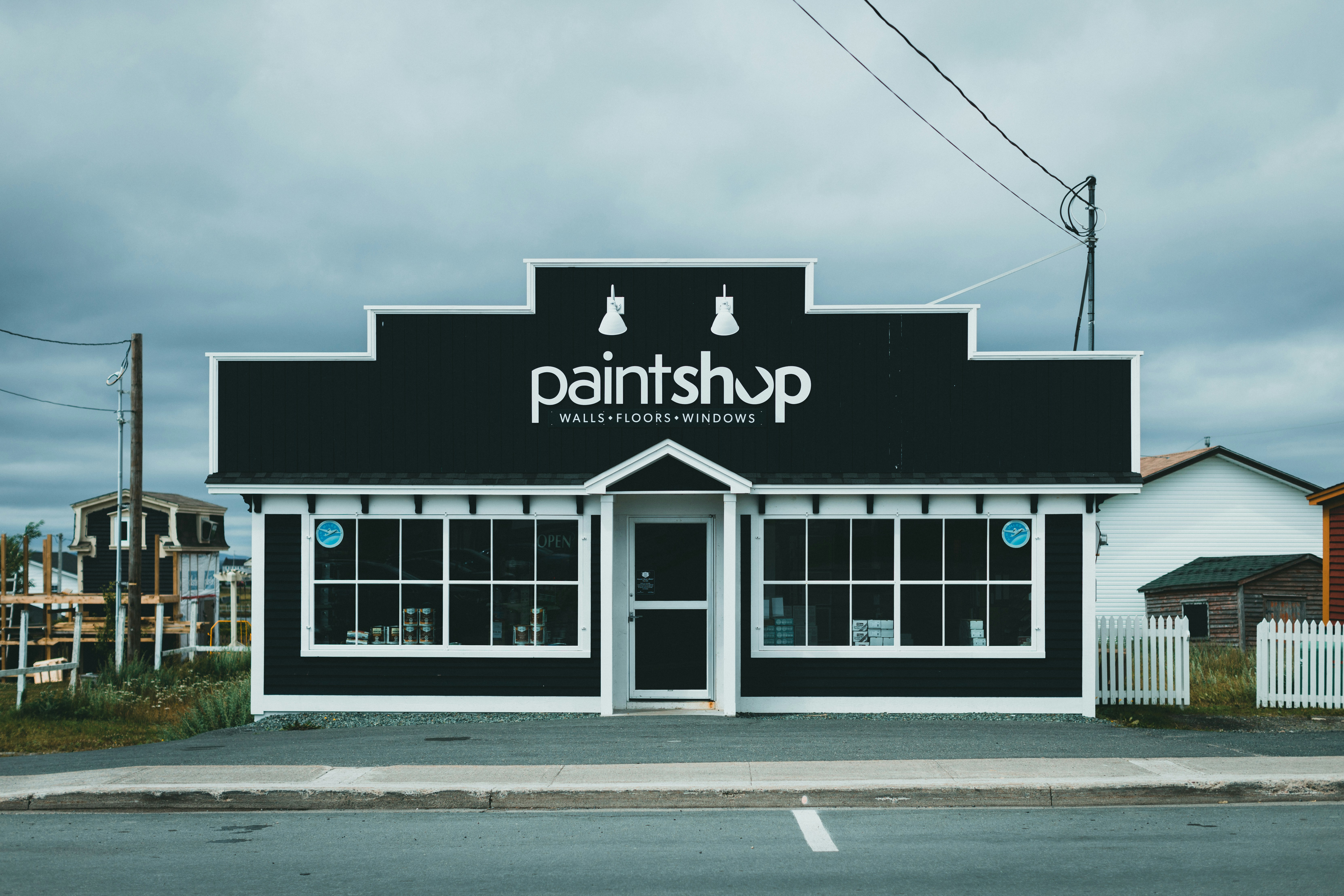 Black weatherboard paint shop building