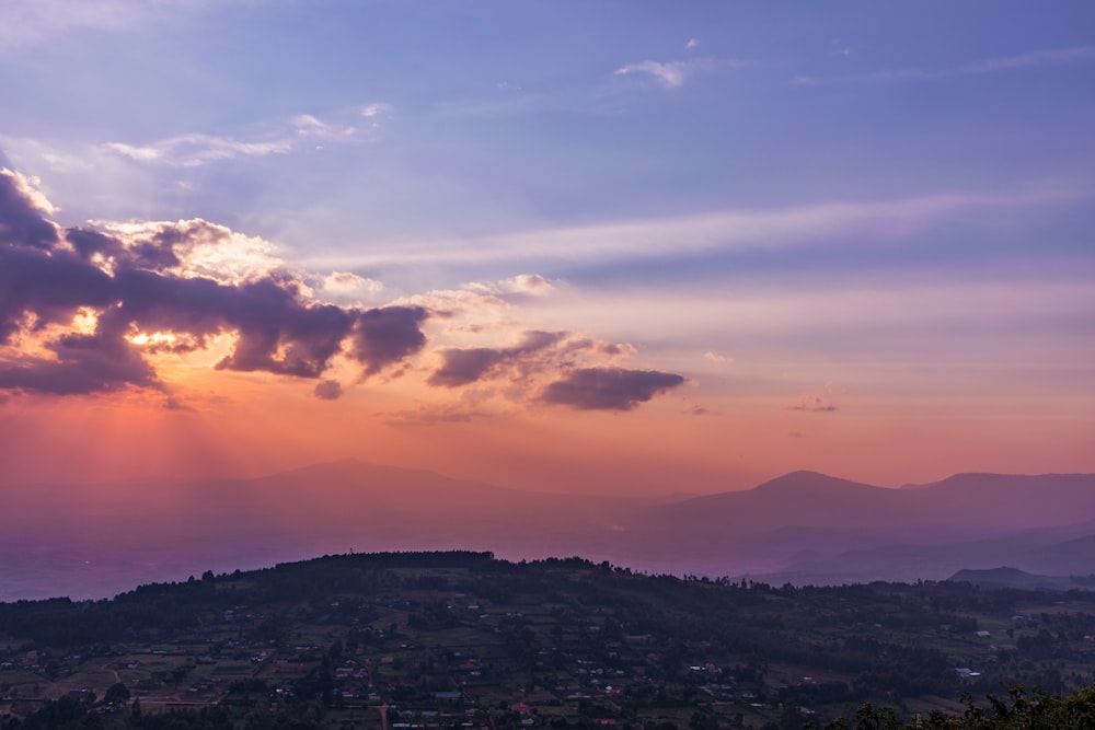 a landscape with hills and clouds