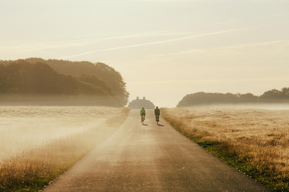 a couple people walking on a path by a body of water