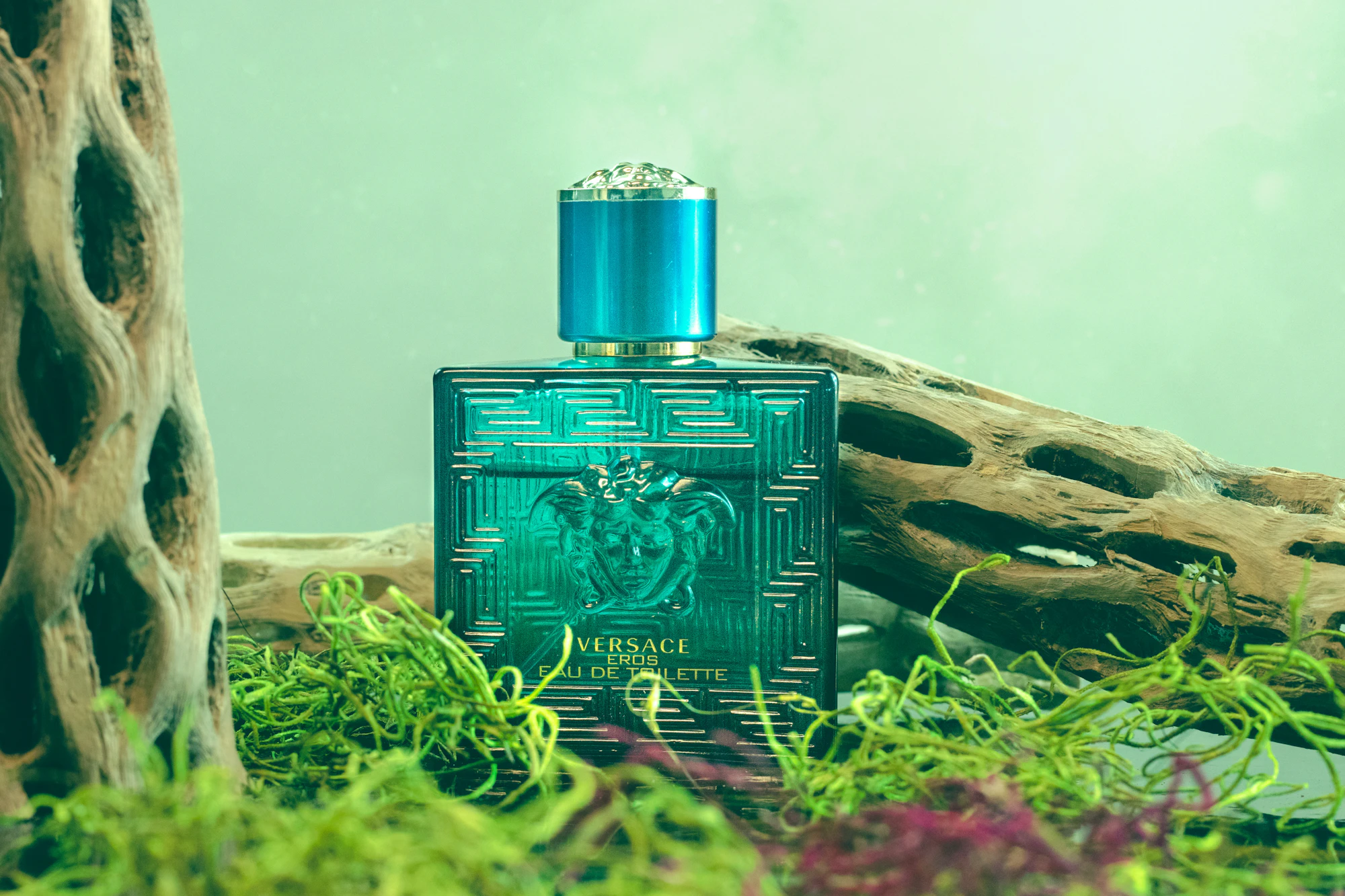A vintage perfume bottle photographed on a dark surface with soft side light