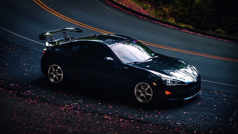 a black sports car on a road