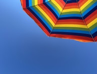 A customized umbrella featuring a unique design, standing out at an outdoor event under a clear sky.