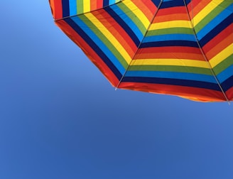 A customized umbrella featuring a unique design, standing out at an outdoor event under a clear sky.