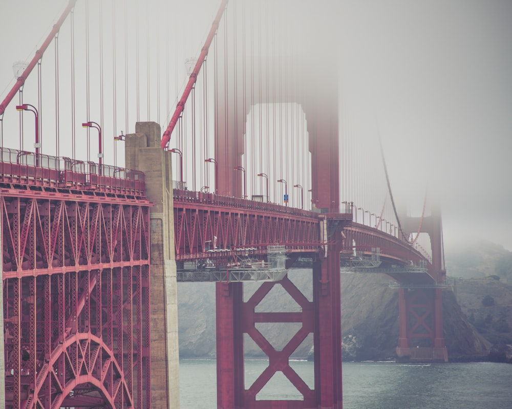 a large red bridge over water