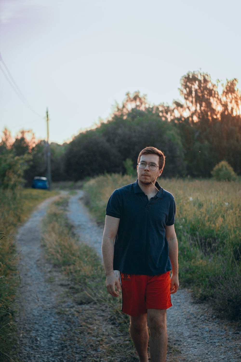 a man standing on a dirt road