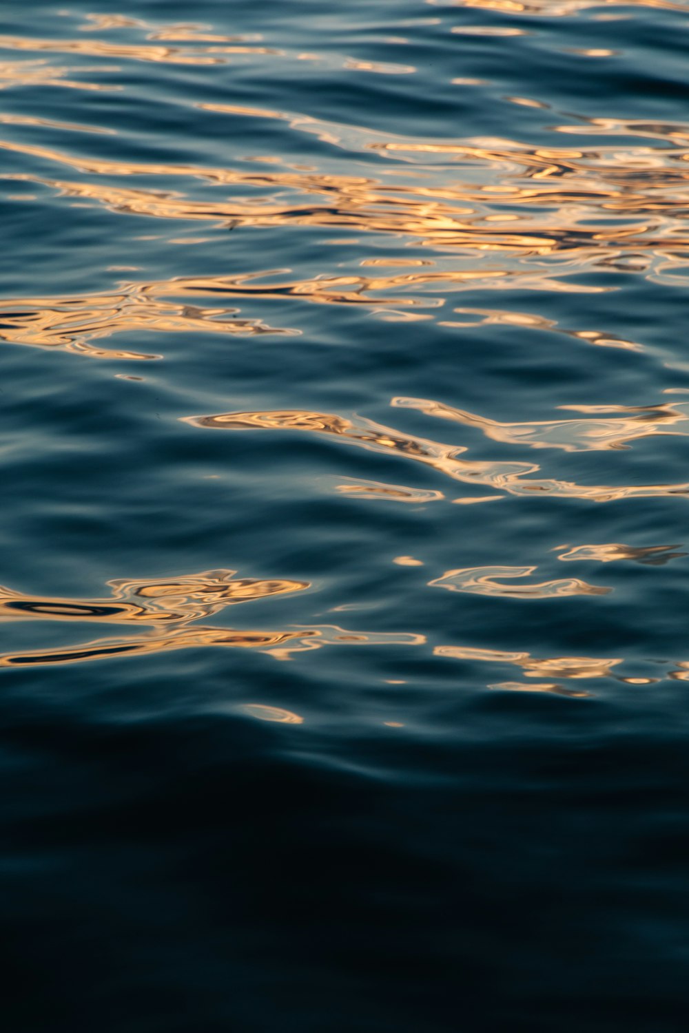 a body of water with clouds above it