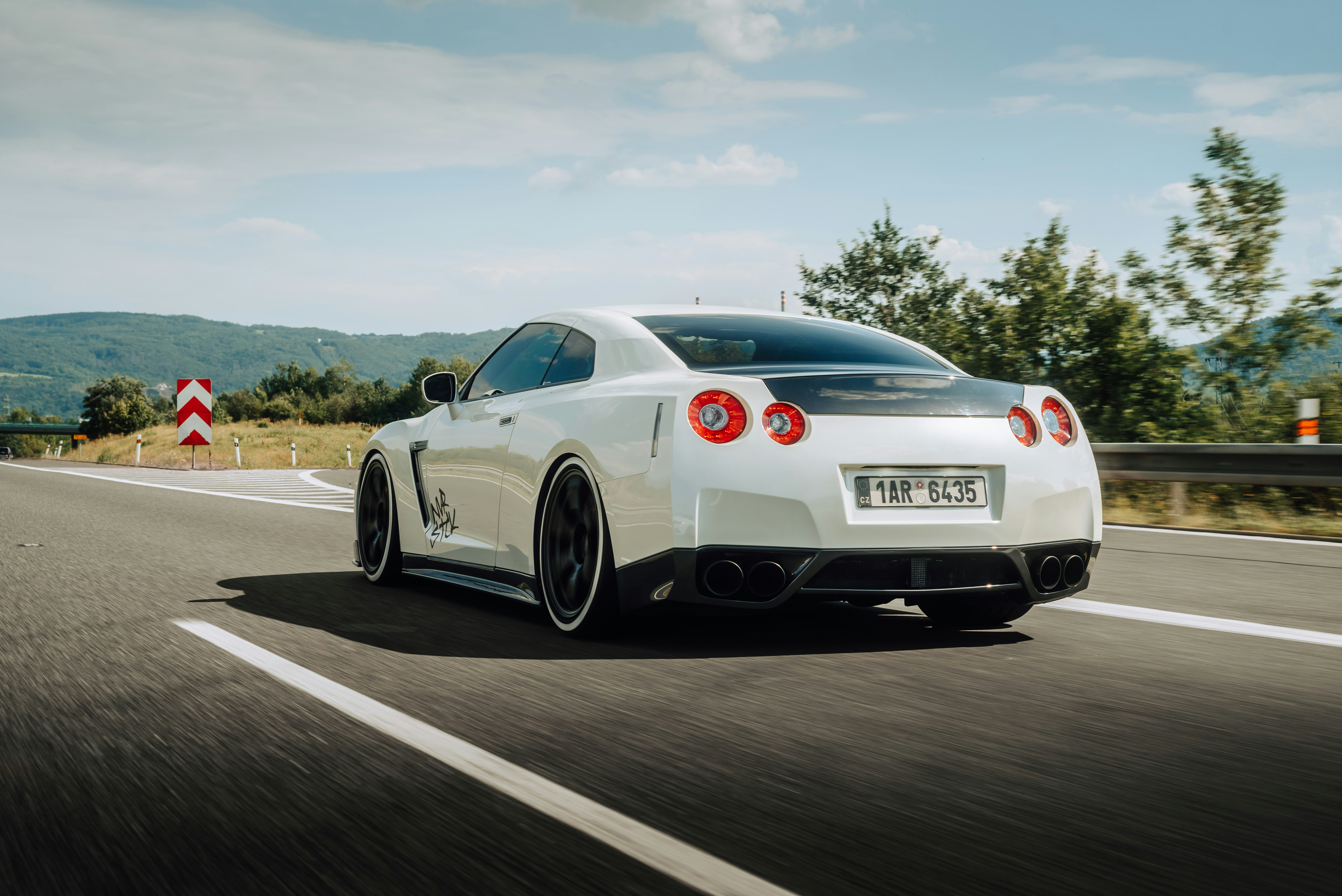 a white sports car on a road