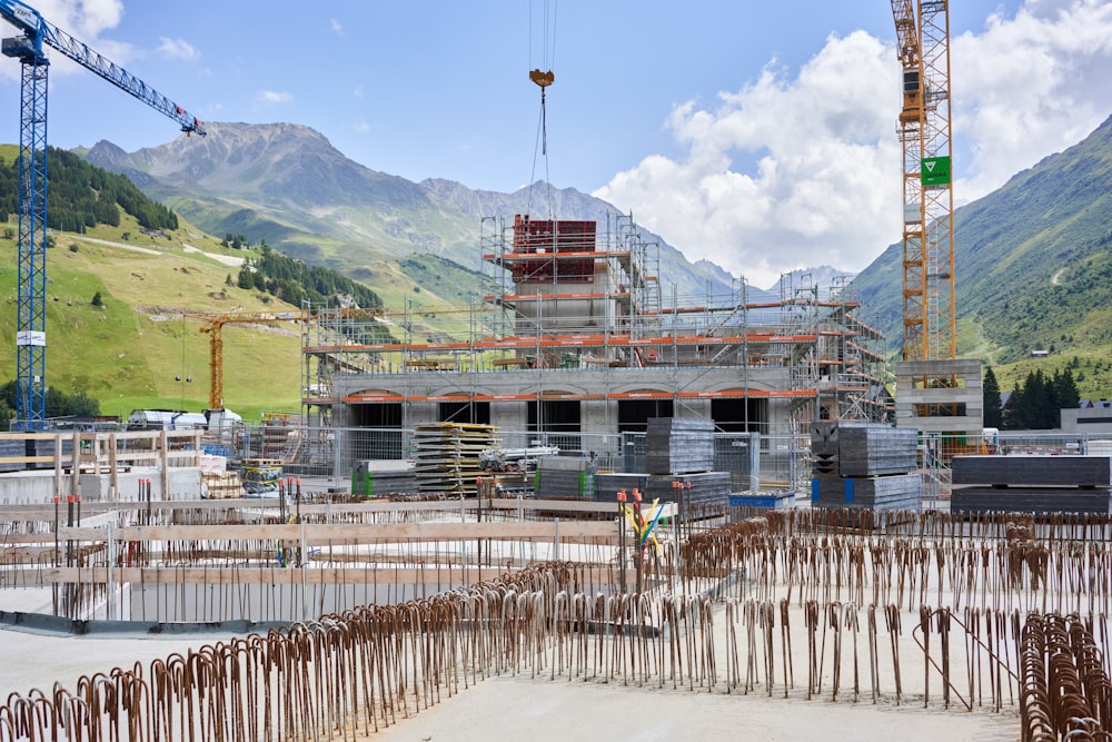 a construction site with cranes and a building under construction