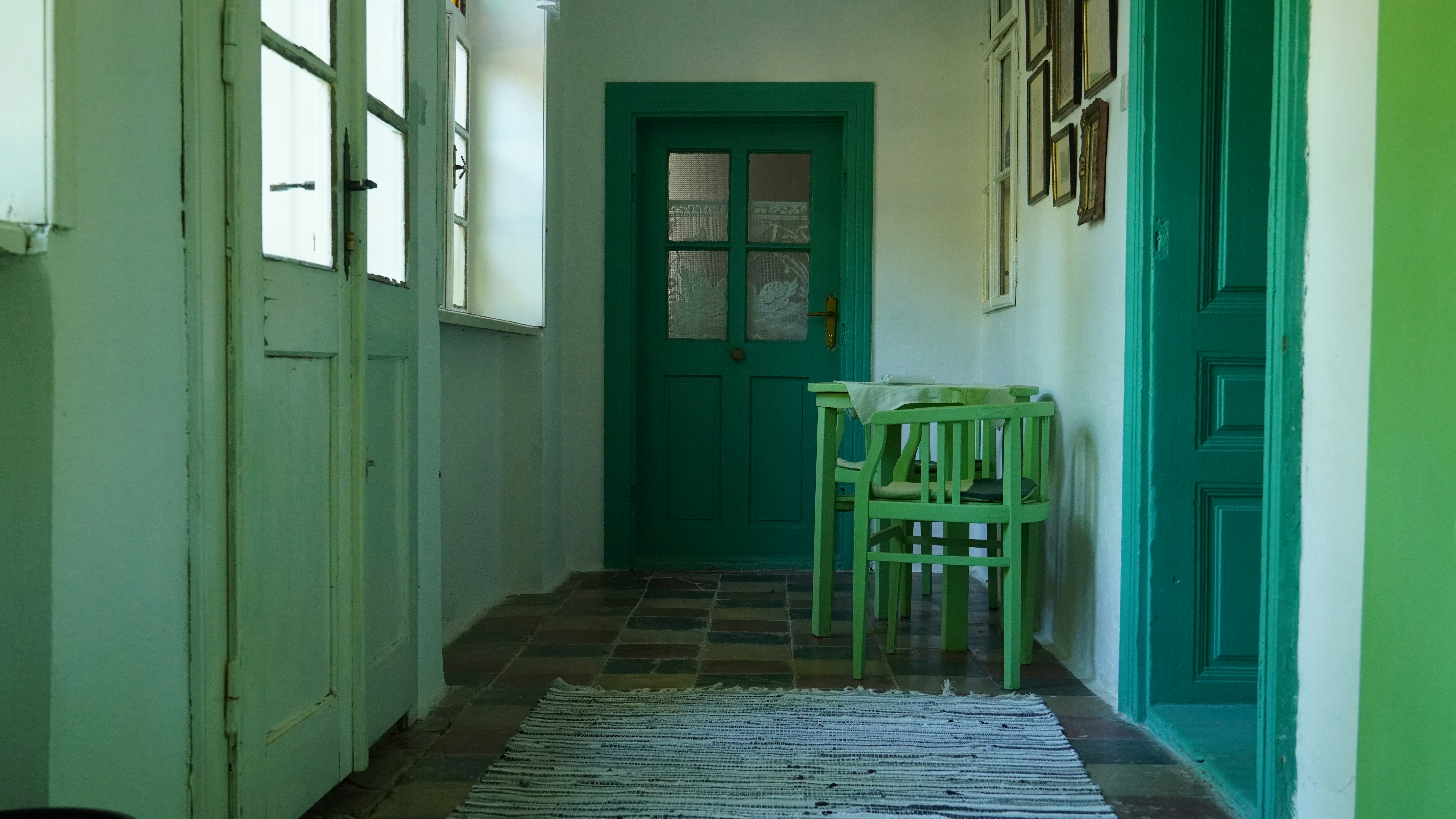 a room with green doors and a table