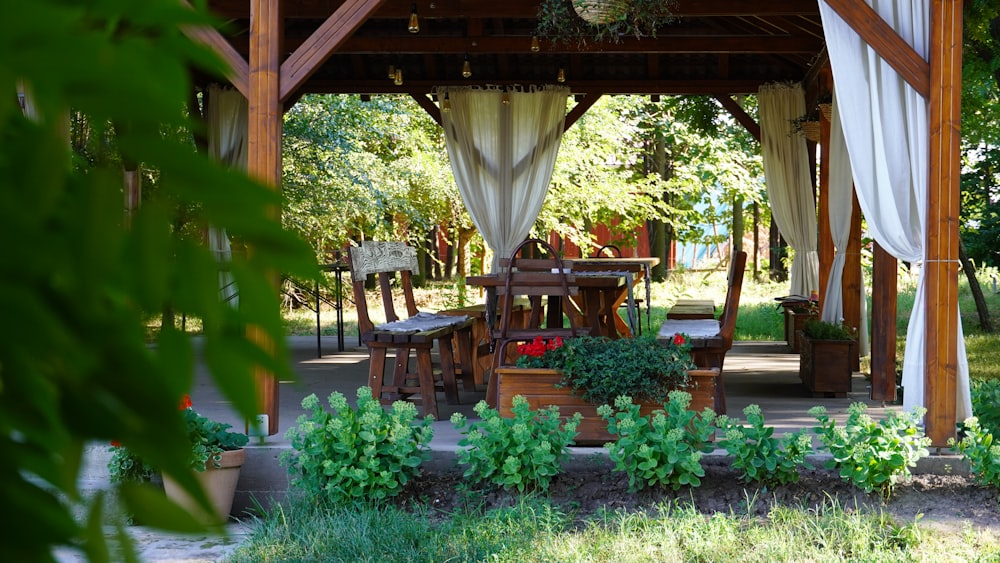 a patio with chairs and plants